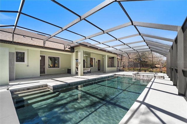 view of pool with a lanai, a patio area, and a pool with connected hot tub