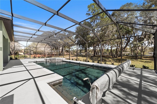 view of pool with a patio area, a lanai, and a pool with connected hot tub