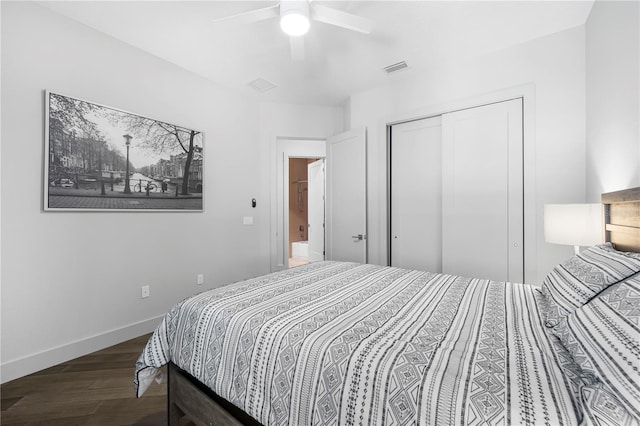 bedroom with ceiling fan, wood finished floors, visible vents, baseboards, and a closet