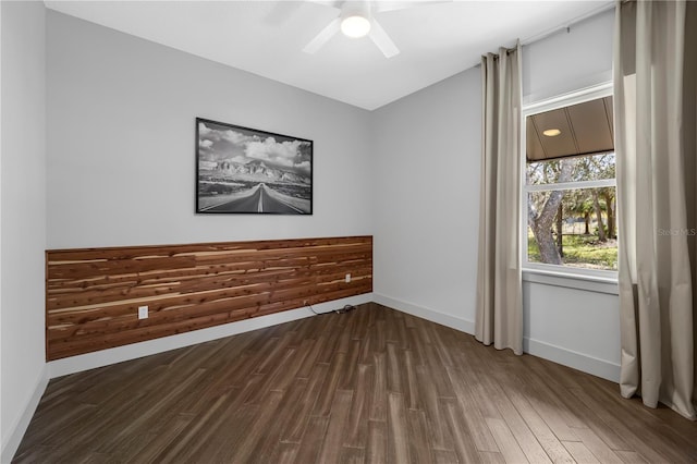 unfurnished room featuring ceiling fan, baseboards, and wood finished floors