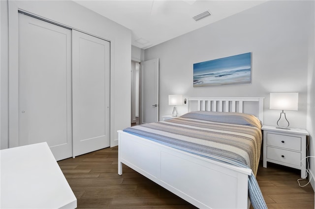 bedroom featuring a closet, visible vents, and wood finished floors