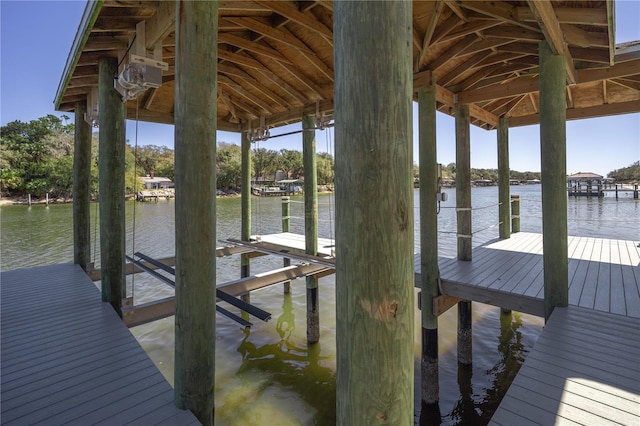 dock area with a water view and boat lift