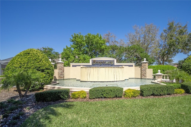 community sign featuring a lawn