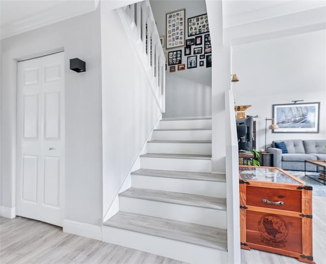 stairway featuring baseboards and wood finished floors