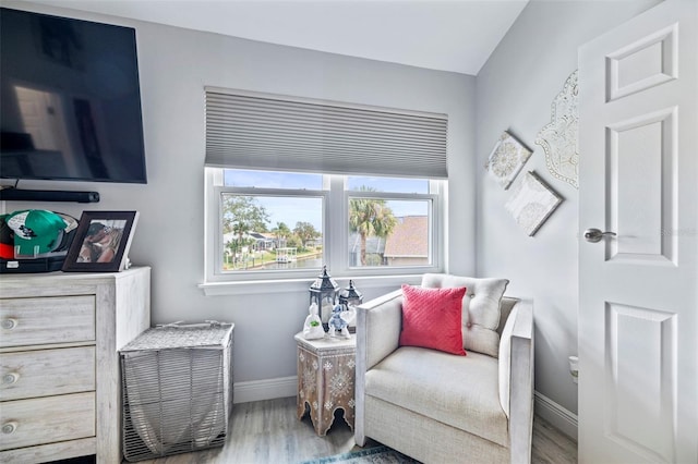 living area featuring baseboards and wood finished floors