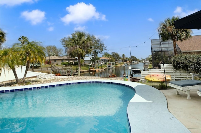 pool featuring a boat dock, a water view, fence, and a patio