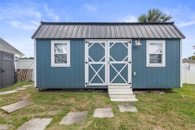 view of shed featuring fence