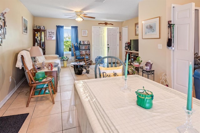 dining room featuring light tile patterned floors, a ceiling fan, and baseboards