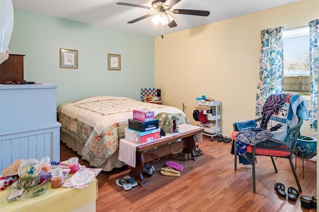 bedroom with a ceiling fan and wood finished floors