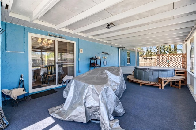 view of patio / terrace featuring fence and a hot tub