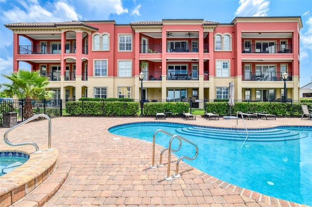 community pool with fence and a patio