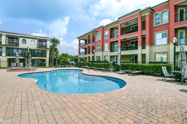 view of pool featuring a patio and fence