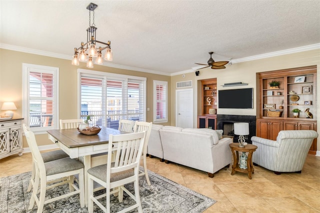 dining space featuring a textured ceiling, visible vents, crown molding, and ceiling fan with notable chandelier