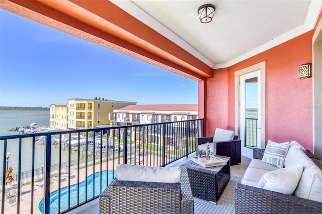 balcony with outdoor lounge area and a water view