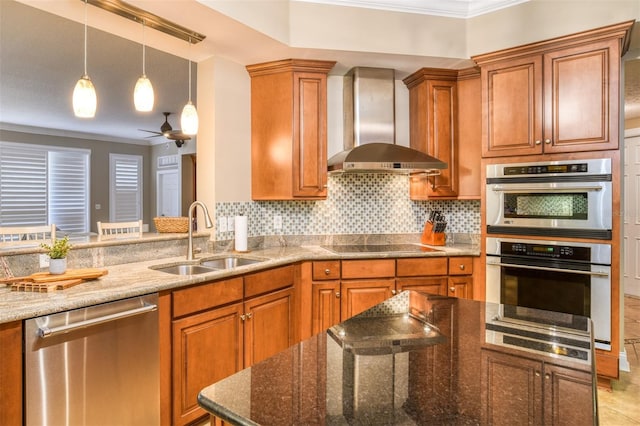 kitchen featuring stainless steel appliances, wall chimney range hood, brown cabinetry, and a sink