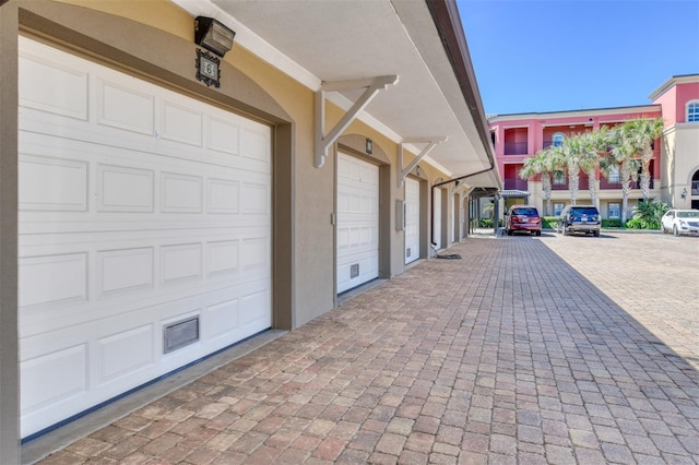 garage featuring decorative driveway