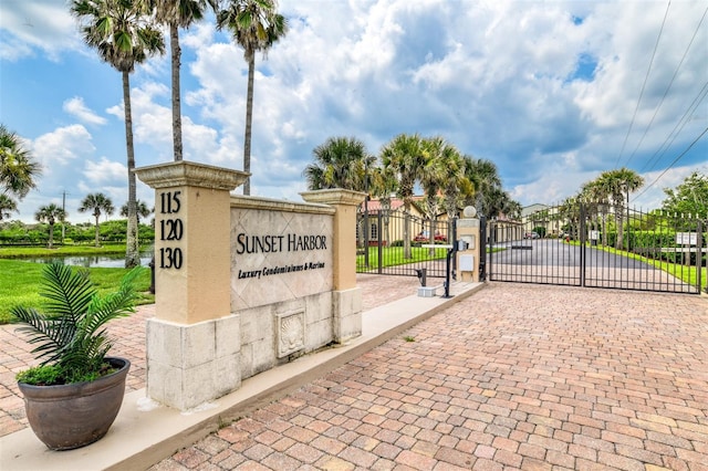 community sign with a gate and fence