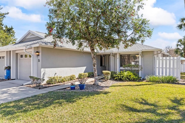 single story home with stucco siding, a front lawn, fence, concrete driveway, and an attached garage