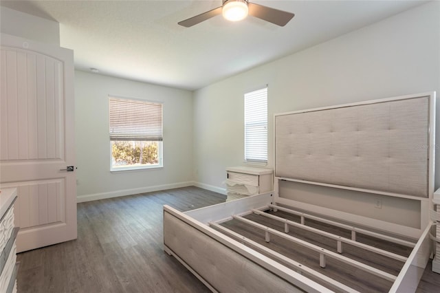 6 Zamia Pl, Palm Coast, FL 32164 - unfurnished bedroom featuring a ceiling fan, wood finished floors, and baseboards