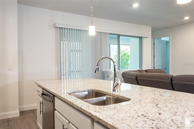 6 Zamia Pl, Palm Coast, FL 32164 - kitchen featuring open floor plan, stainless steel dishwasher, light wood-type flooring, and a sink
