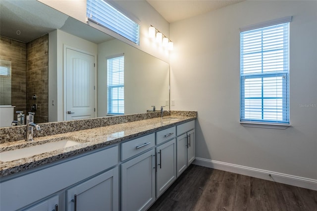 6 Zamia Pl, Palm Coast, FL 32164 - full bath featuring a sink, baseboards, tiled shower, and wood finished floors