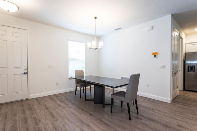 6 Zamia Pl, Palm Coast, FL 32164 - dining area with a notable chandelier, wood finished floors, visible vents, and baseboards