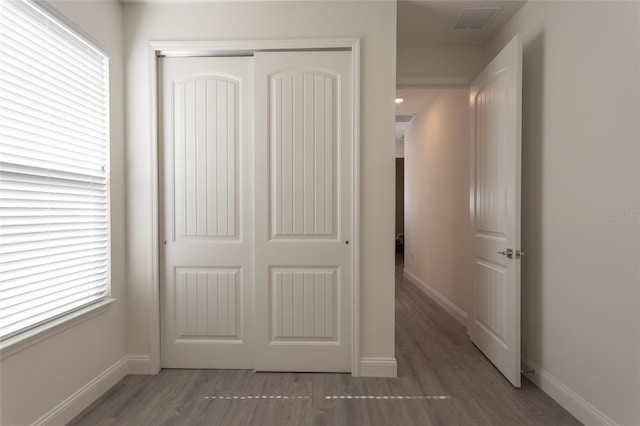 6 Zamia Pl, Palm Coast, FL 32164 - unfurnished bedroom with a closet, visible vents, baseboards, and wood finished floors