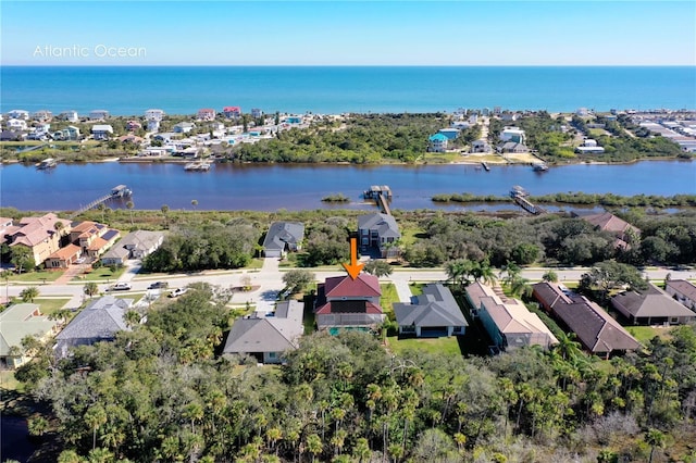 drone / aerial view with a residential view and a water view