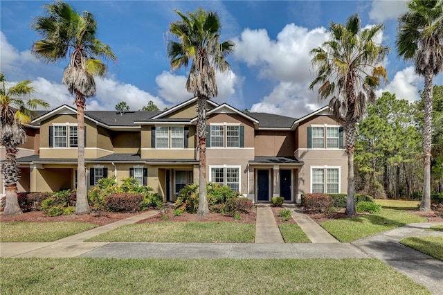 view of front of property with a front lawn and stucco siding