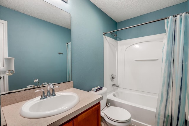 bathroom with toilet, shower / tub combo with curtain, a textured ceiling, and vanity