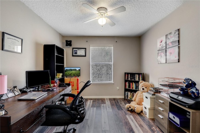 office with a ceiling fan, baseboards, a textured ceiling, and hardwood / wood-style floors