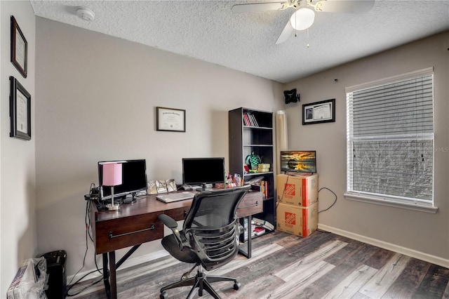 office space with plenty of natural light, baseboards, ceiling fan, wood finished floors, and a textured ceiling