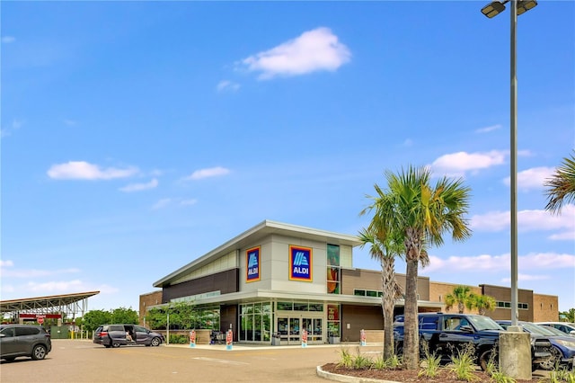 view of building exterior with uncovered parking