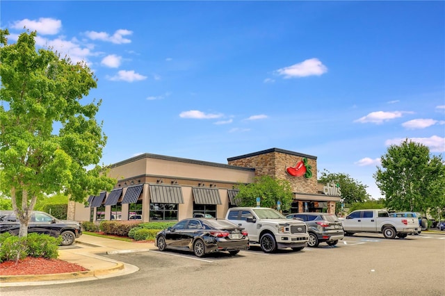 view of property featuring uncovered parking