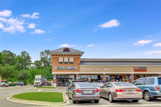 view of building exterior with uncovered parking