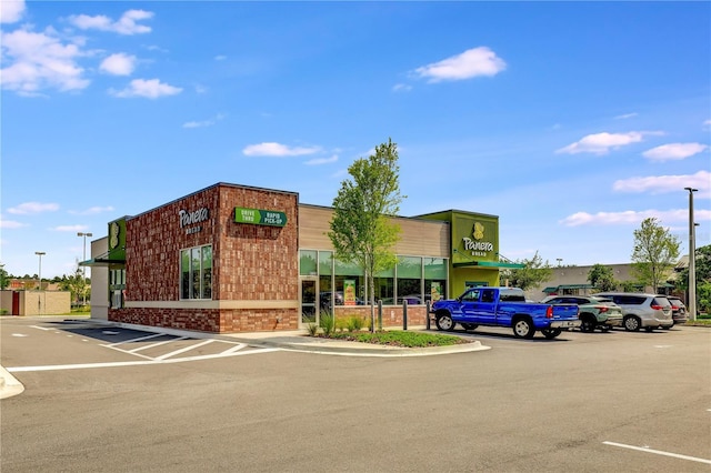 view of building exterior with uncovered parking