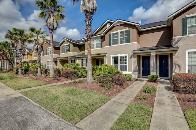 view of property with a residential view and stucco siding