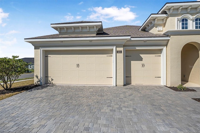 garage featuring decorative driveway