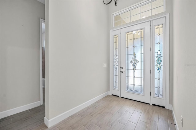 foyer featuring wood finish floors and baseboards