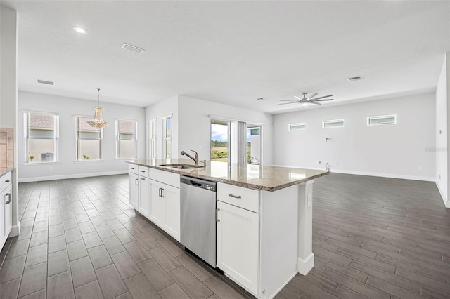 kitchen featuring stainless steel dishwasher, wood finish floors, a center island with sink, and a sink