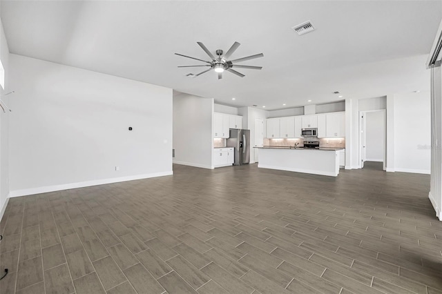 unfurnished living room featuring dark wood-style floors, recessed lighting, a ceiling fan, and visible vents