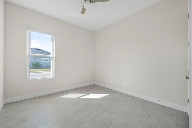 unfurnished room featuring baseboards, light wood finished floors, and ceiling fan