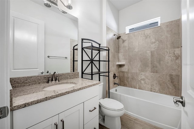 bathroom featuring tub / shower combination, toilet, and vanity