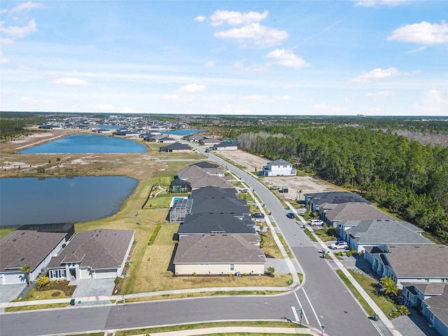 birds eye view of property with a residential view and a water view