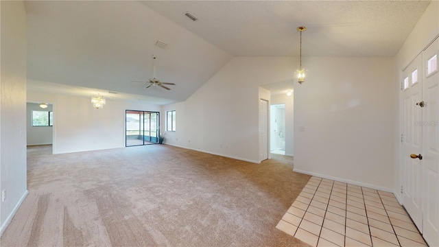 spare room featuring visible vents, high vaulted ceiling, a ceiling fan, baseboards, and light colored carpet