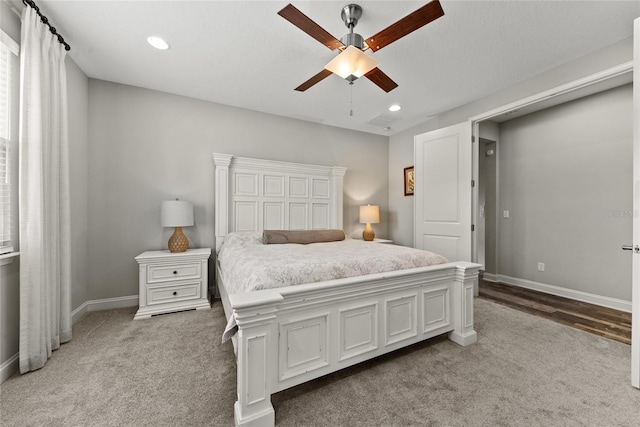 bedroom with recessed lighting, light carpet, and baseboards