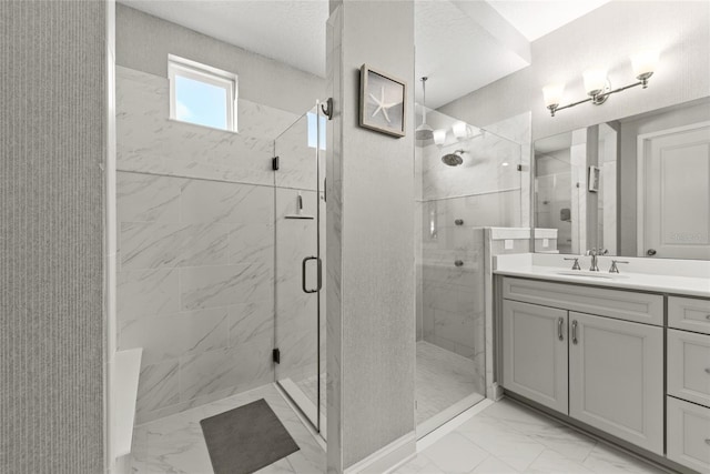 bathroom featuring marble finish floor, vanity, and a marble finish shower