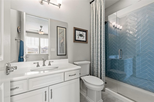 bathroom featuring ceiling fan, a shower stall, toilet, and vanity