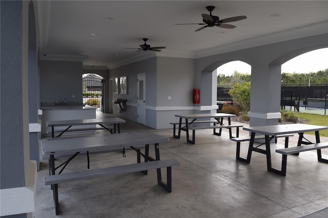 view of patio / terrace featuring outdoor dining space, fence, a ceiling fan, and a gate