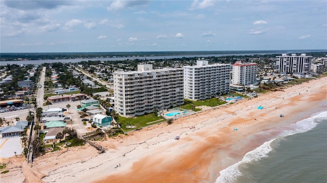 aerial view with a water view, a view of city, and a beach view